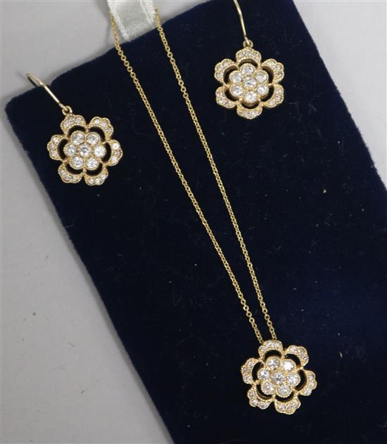 A 14ct gold and diamond flowerhead pendant on a 14ct gold fine link chain and a pair of matching earrings.
